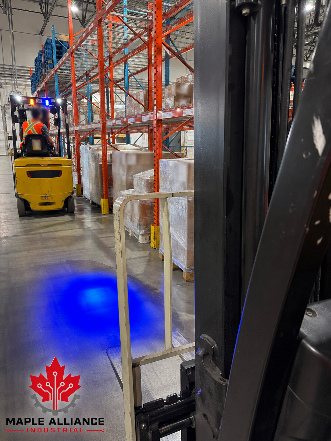 Blue forklift safety light in use inside a warehouse